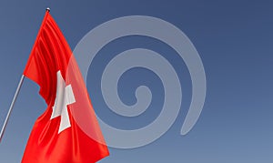 Switzerland flag on flagpole on blue background. Place for text. The flag is unfurling in wind. Swiss, Bern. Europe. 3D