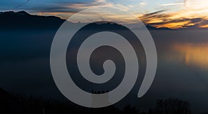 Switzerland:  Sunset on Lake Geneva in early November with the colors of it and a clear cloud