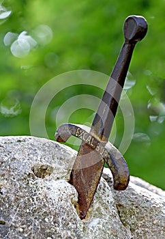 Sword excalibur of King Arthur stuck in the rock photo