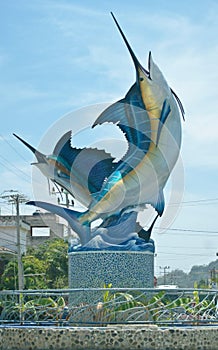 Swordfish marlin fish pez vela sculpture on the street in a town by the beach outside a restaurant bar hotel photo