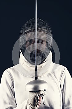 Swordsman in the fencing suit photo