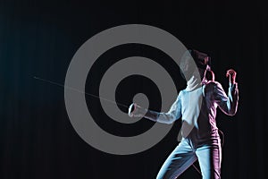 Swordswoman fencing with rapier isolated on