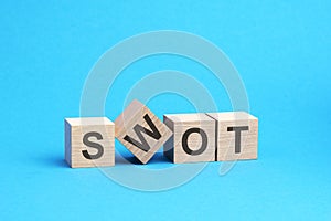 swot text on wooden blocks, business concept, blue background