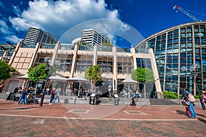 SYDNEY - AUGUST 19, 2018: Buildings and tourists along Darling Harbour on a beautiful day