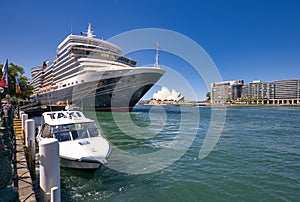 viView of cruise liner, taxi boat at Circular Quay area, Opera House visible on the background
