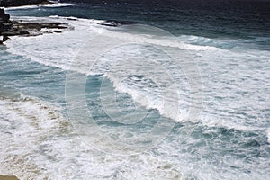 Sydney beach. Sea waves and rocks. Top view