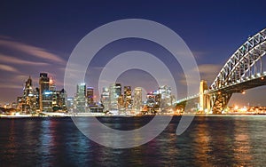 Sydney cityscape at night, reflection on harbour.