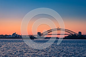 Sydney Harbor Bridge and Opera House during Sunset seen from the Sea, New South Wales, Australia