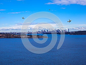 Sydney Harbour with the CBD in the background NSW Australia. planes in sky