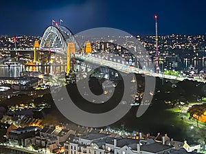 Sydney Harbour at night with the bridge in view and cars on the roads NSW Australia
