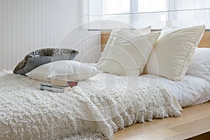 Sylish bedroom interior with black and white pillows on bed