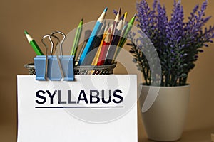 SYLLABUS - word on a white sheet against the background of pencils and a bouquet of lavender