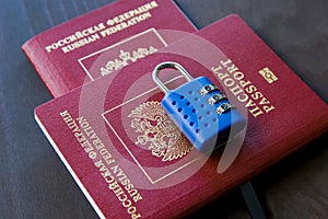 Symbol of anti-Russian sanctions. Two Russian passports locked to padlock