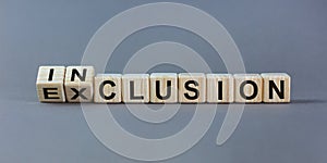 Symbol for a better inclusion. Inverted cube and changed word exclusion to inclusion. Beautiful grey background. Copy space photo