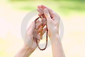 symbol of christianity, wooden rosary in hands