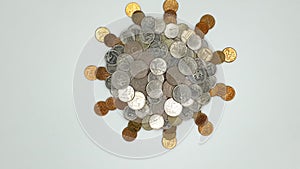 Symbol of coronavirus COVOD-19 made from coins. Heap of metal coins looks like round object with rays.