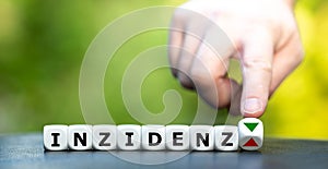 Symbol for a decreasing incidence rate `inzidenz` in German during the corona crisis. photo