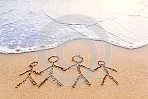 Symbol of family drawn in the sand, parents, children, together