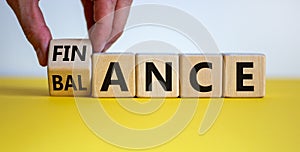 Symbol for finding the right balance in your finance. Hand turns a cube and changes the word `finance` to `balance`. Beautiful