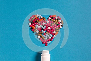 Symbol Heart From Color Pills Medicament On Blue Background. Creativity Medicine Concept