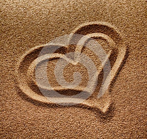 Symbol of heart is drawn on sand
