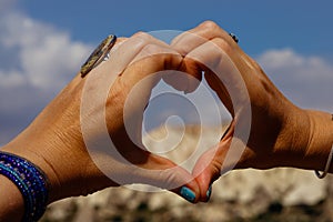 Symbol of heart made up of womens fingers through it is seen Cappadocia