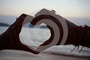 Symbol of love Couple hands making heart shape.