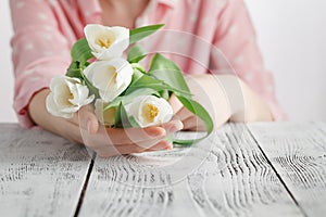 Symbol of love romance, girl has just bestowed a bouquet of white tulips