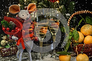 The symbol of the New Year 2020 is the mouse. With a glass of champagne, tangerines, spruce branches and snow flakes