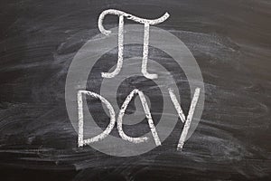 The symbol of number PI day written chalk on a blackboard