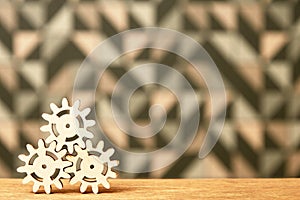 Symbol of puzzle and engineer games with wooden gears and cogs on the table