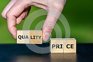 Symbol for selecting a product with a high quality insread of a low price. Wooden cubes form the words quality and price