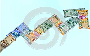 Symbol of stock market, concept, made with new 10,100, 200,and 500 Indian currency on white isolated background