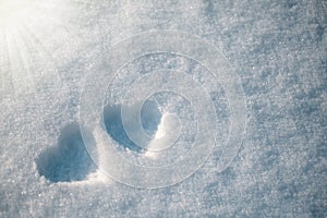 The symbol of two hearts drawn on the snow, on a sunny winter day. Romance. Valentine's Day. Copy space.