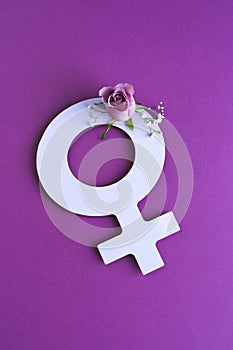 symbol of women\'s day cut out of paper with flowers on purple background