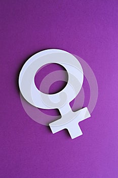 symbol of women\'s day cut out of paper with flowers on purple background