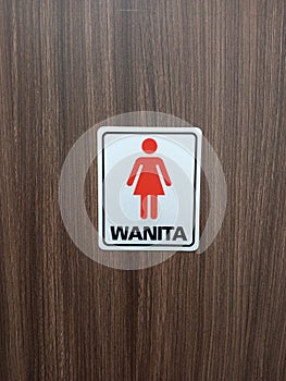 symbol of women's restroom at the entrance of a public restroom in an office building
