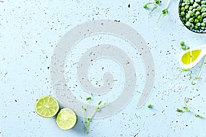 Symbolic food background with lime, pea sprouts, sea salt and frozen peas