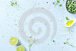 Symbolic food background with lime, pea sprouts, sea salt and frozen peas