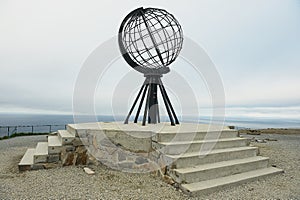 The symbolic globe at the North Cape point in a cloudy weather day in North Cape, Norway.
