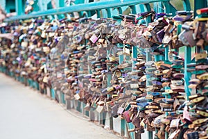 Symbolic love padlocks fixed to the railings of grunwaldzki bridge, Wroclaw, Poland. Shallow depth of field and creamy bokeh photo