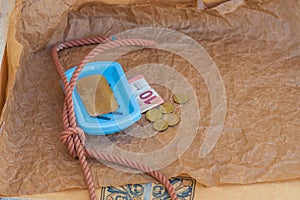 Symbolic scene, solid soap, gallows loop, euro coins, 10 euro banknote. Hopelessness due to lack of earning opportunities,