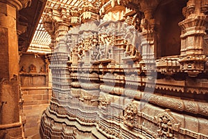 Symbolic sculptures and reliefs in Indian temple wall. Ancient architecture example with Hindu and Jain motifs, India.