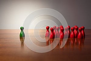 Symbolism wooden red and green figures for business exclusion racism mobbing hate religions