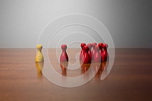 Symbolism wooden red and yellow figures for business exclusion racism mobbing hate religions