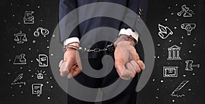 Symbols of courthouse with handcuffed man