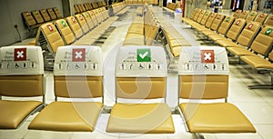 Symbols on special chairs or specific seat keep social distancing is applied waiting at airport during  pandemic coronavirus,New