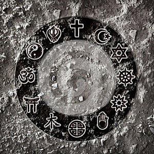 Symbols of various world religions on gray textured earth background photo