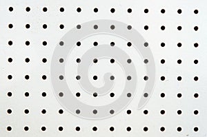 Symetrical holes on a white pegboard