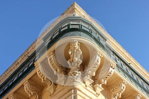 Symmetric central corner view of facade wity big traditional balcony of Grandmaster Palace in Valletta